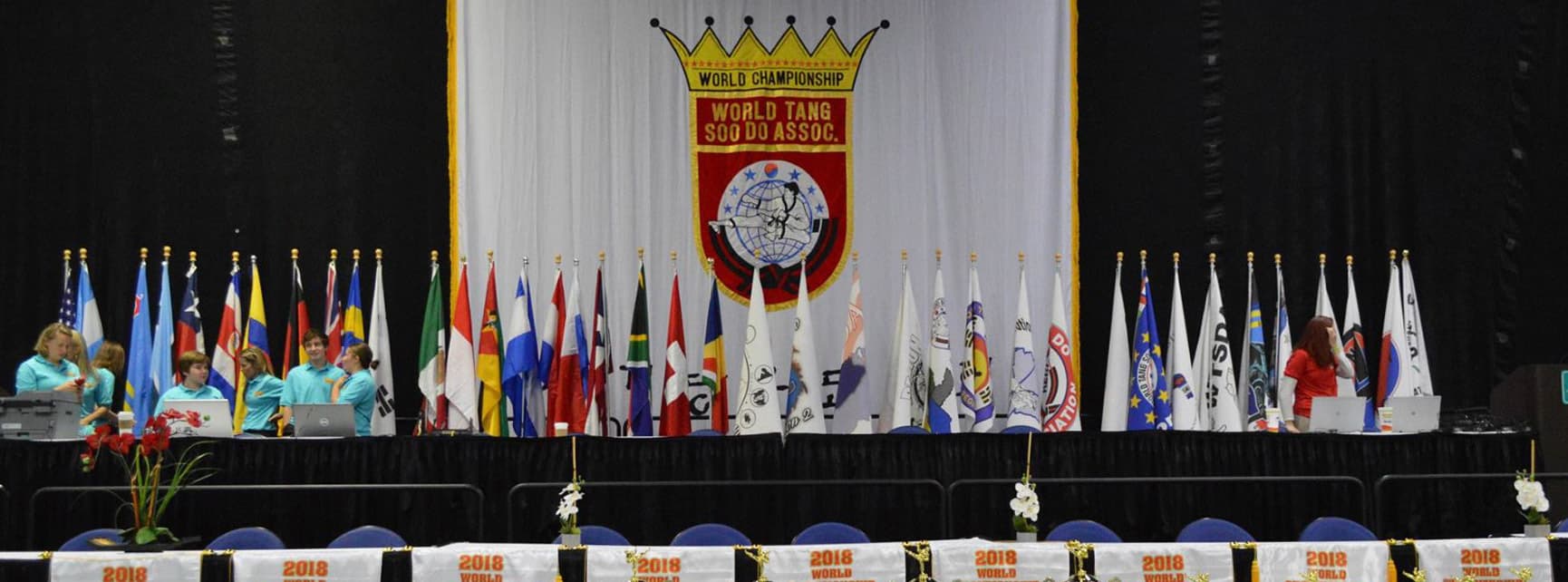 The head table at a WTSDA World Championship, staffed and set up in front of the competing nations' flags.